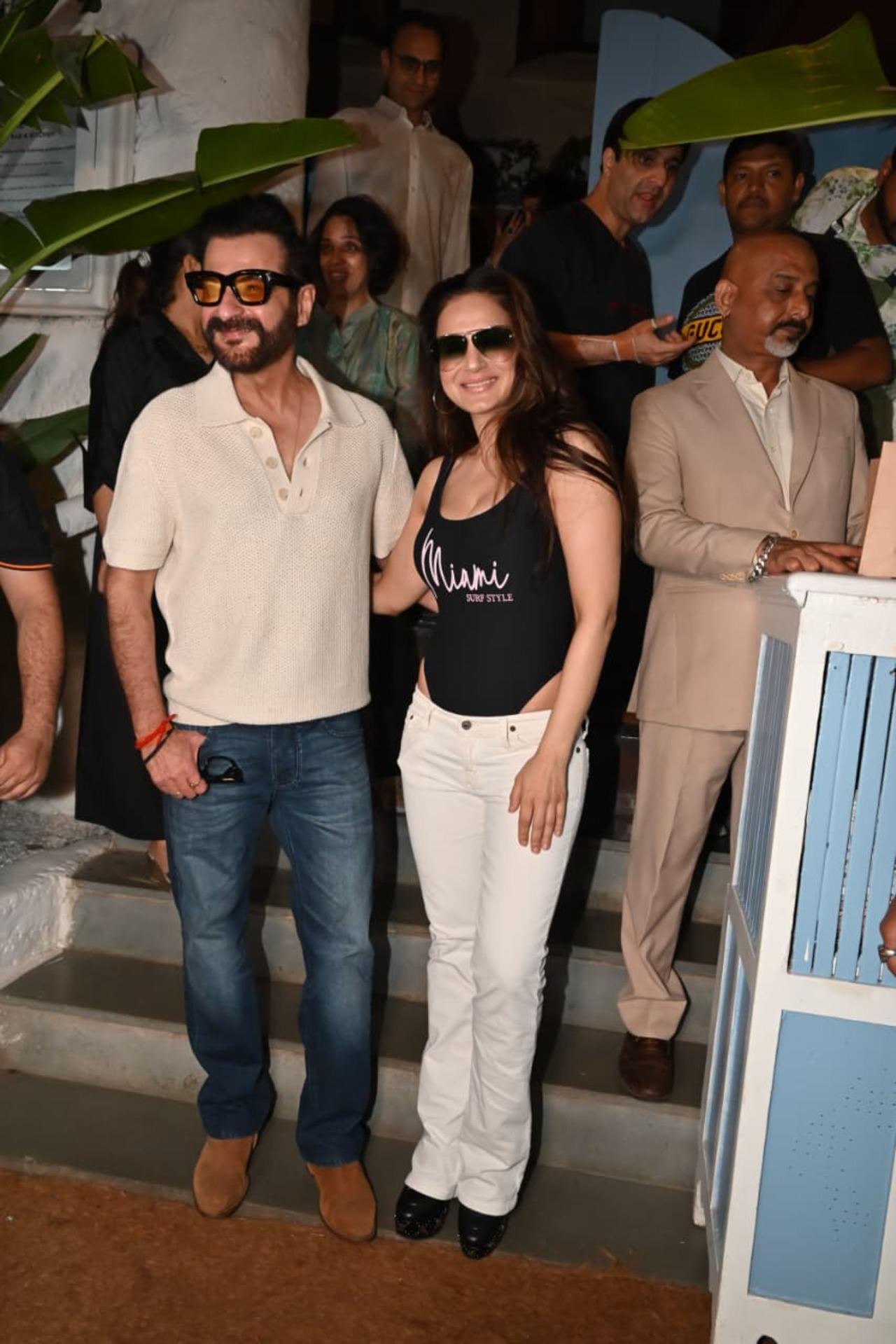 Sanjay Kapoor and Ameesha Patel seemingly bumped into each other and posed for paps as they exited a restaurant during wee hours on Friday.